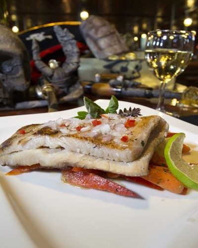 Grilled mahi-mahi with lemon and herbs, offering a fresh and delicious seafood option for guests on the Jolly Roger.