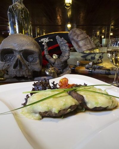 Grilled portobello mushrooms stuffed with flavorful fillings, served onboard the Jolly Roger as part of its dining menu.