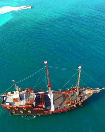 The Jolly Roger pirate ship cruising through Cancun’s waters, offering a unique, immersive pirate adventure for guests.