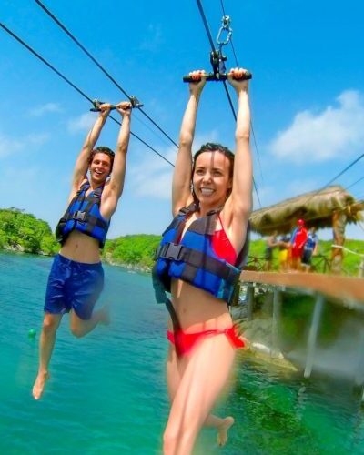 Adventurous traveler enjoying a thrilling salpichanga zip line experience in the lush jungles of Cancun, Mexico.