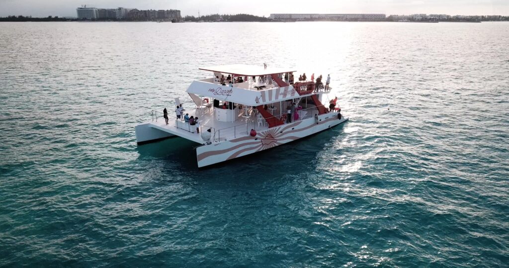 Baby Dancer catamaran sailing in Cancun with travelers enjoying the Caribbean Sea
