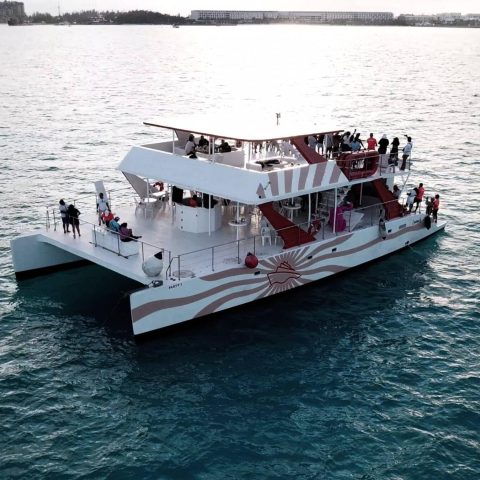 Travelers on board a baby dancer taking in the picturesque views of Cancun