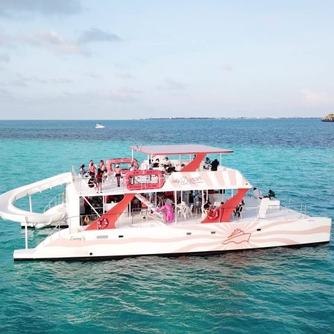Baby Dancer catamaran sailing in Cancun with travelers enjoying the Caribbean Sea
