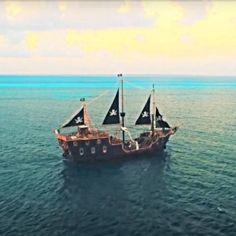 Aerial view of the Jolly Roger pirate ship on the water in Cancun, providing a unique pirate-themed experience for visitors.