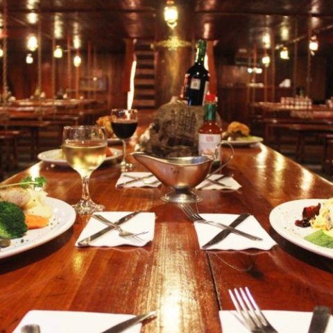 Guests dining and enjoying live entertainment on the Jolly Roger, creating a memorable pirate-themed experience.