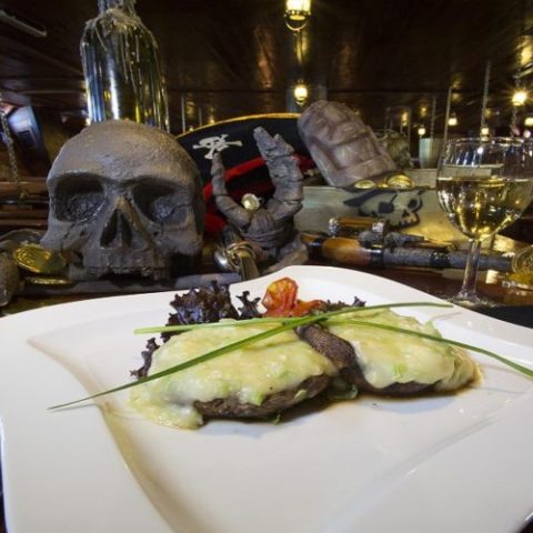 Grilled portobello mushrooms stuffed with flavorful fillings, served onboard the Jolly Roger as part of its dining menu.