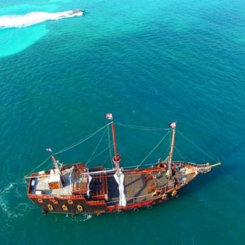 The Jolly Roger pirate ship cruising through Cancun’s waters, offering a unique, immersive pirate adventure for guests.